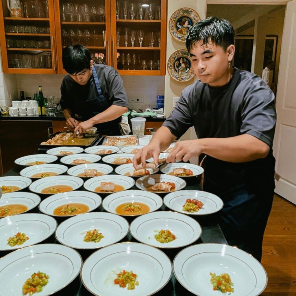 Photo of two men plating food