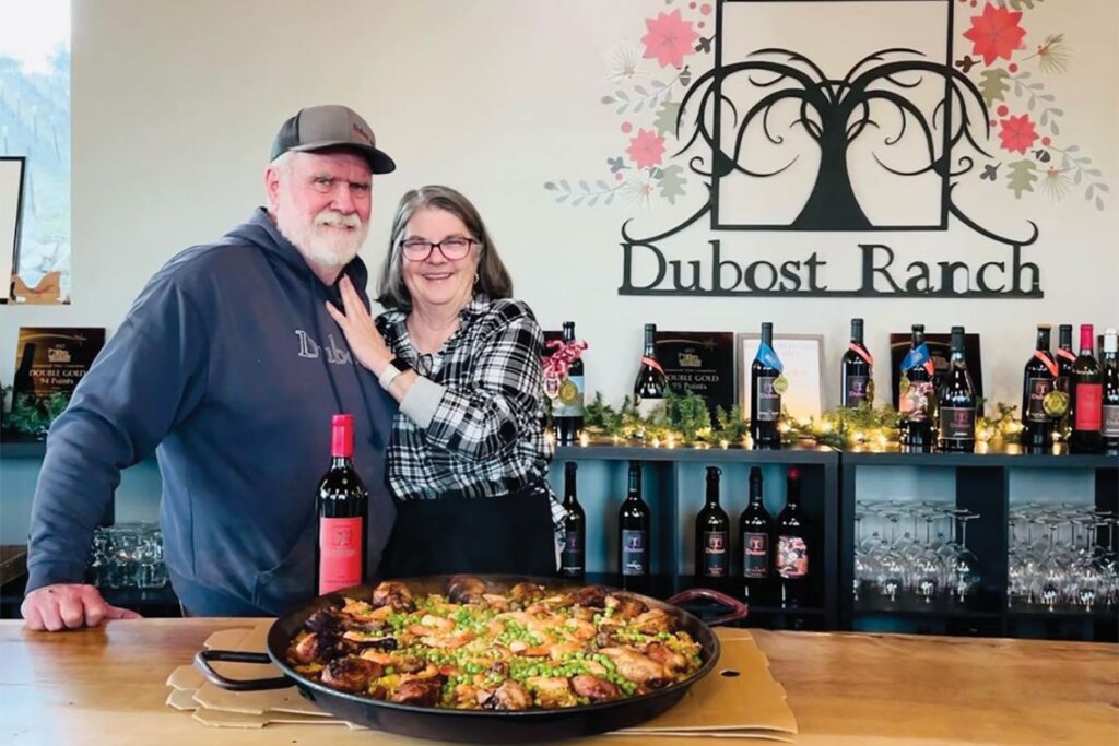 Kate and Curt Dubost with a paella and their wine ahead of an event