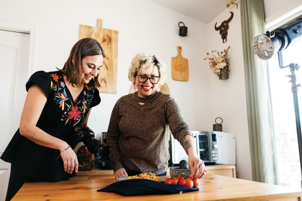 Candice, a private chef and resident chef at Kindred Oak Farm, prepares recipes of her cookbook as Ariette Armella snaps photos.