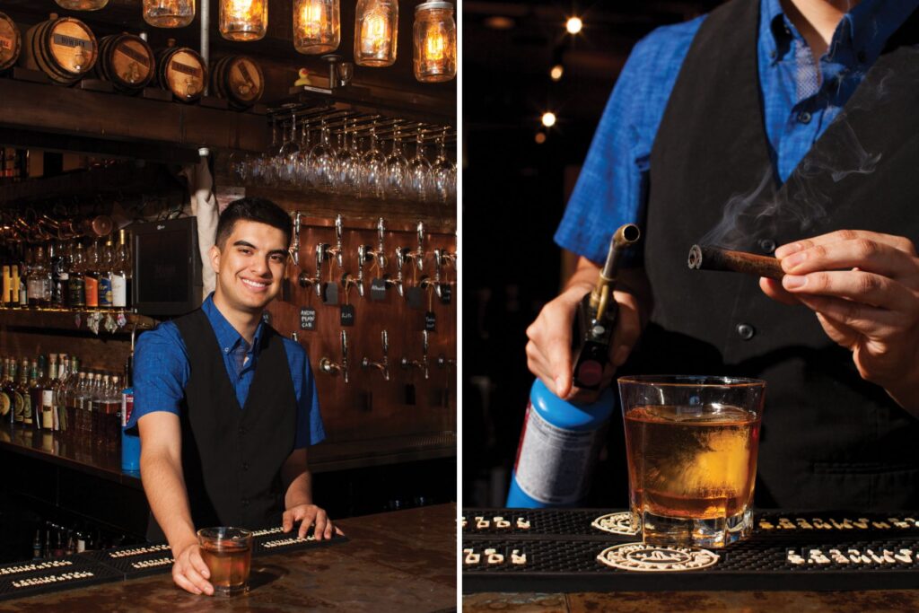 Man behind bar, lighting cinnamon stick.