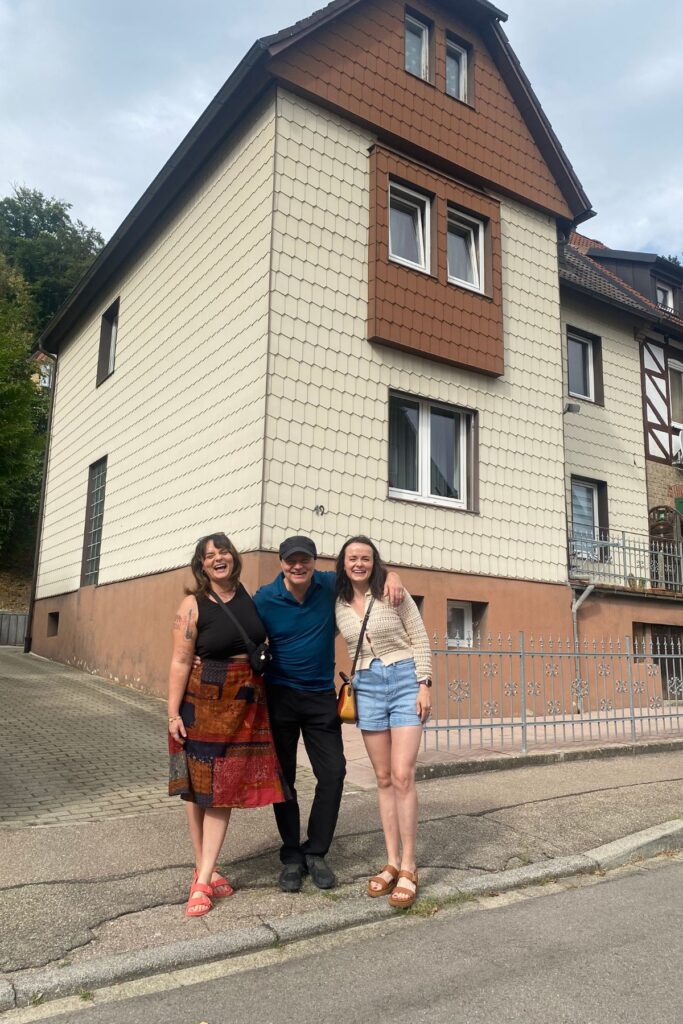 Aja with her father and sister outside her grandmother’s childhood home.