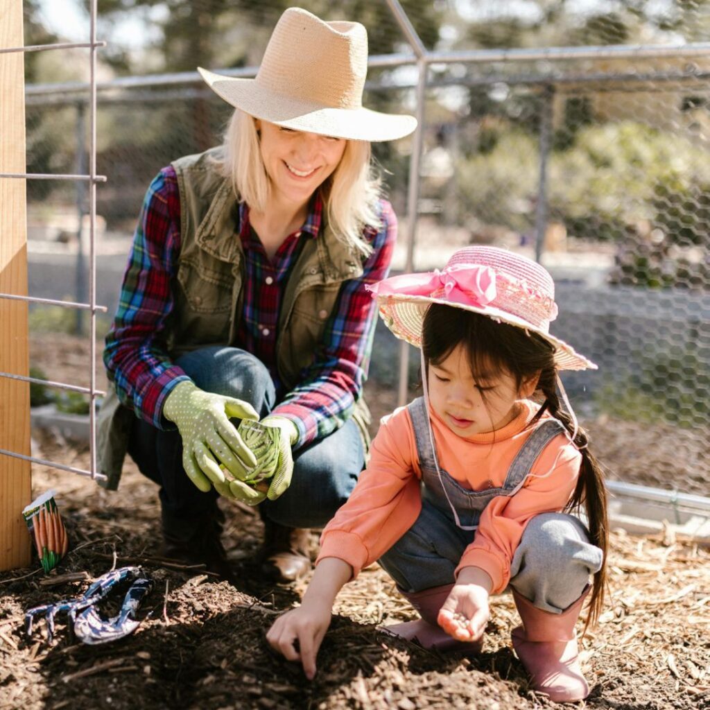 Woman and child planting seeds