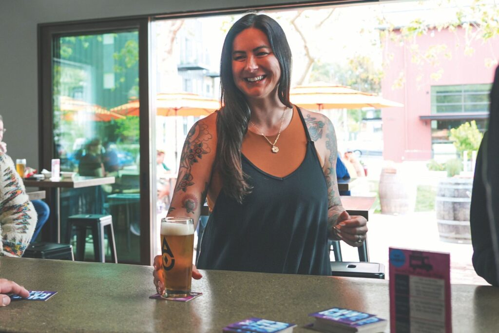 Co-owner Alanna Andruszkiewicz with a pint at the bar.