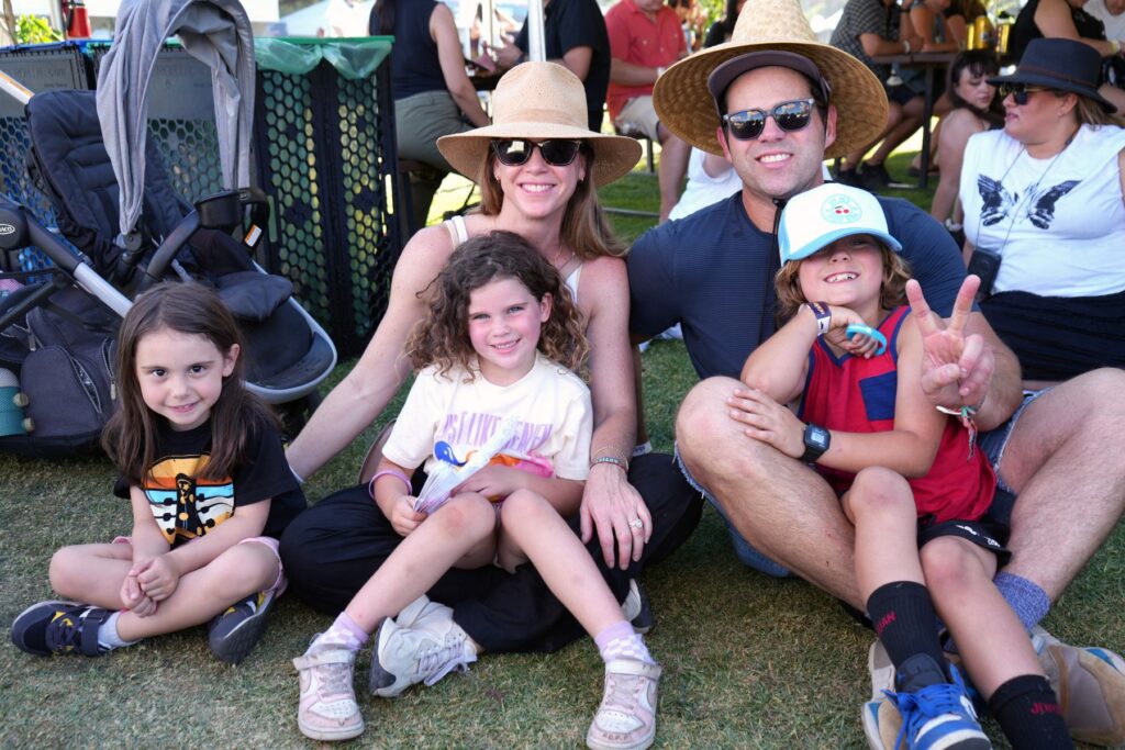 Family posing for photo at concert festival.