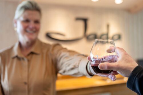 Woman handing wine drink
