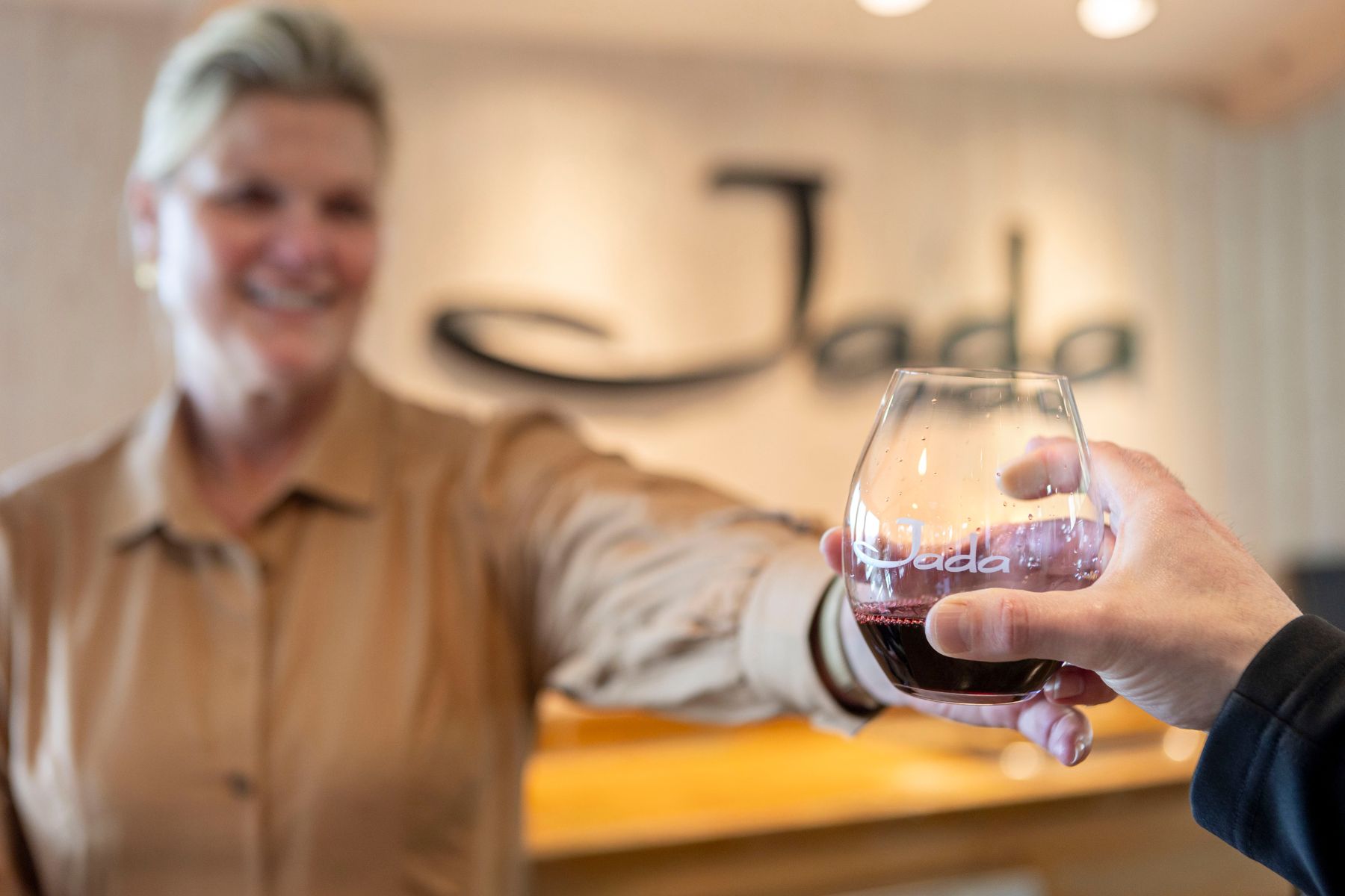 Woman handing wine drink