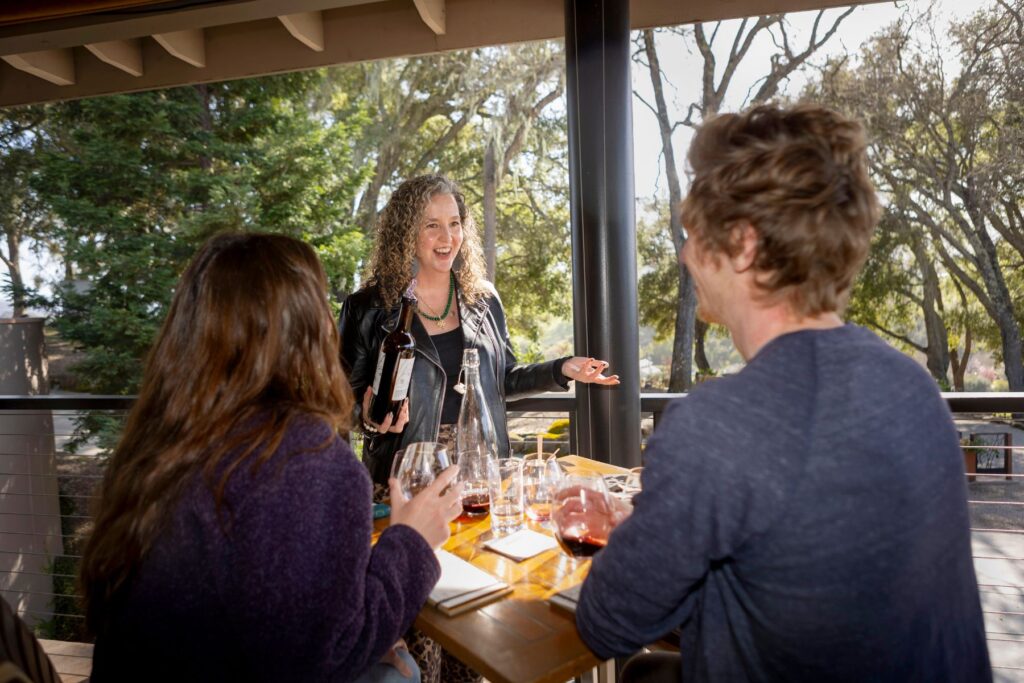 Three people at a vineyard tasting room