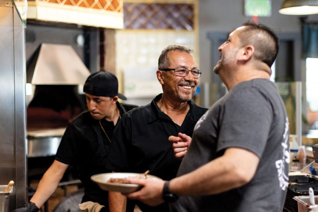 David and co-workers stop to share a laugh during the dinner rush.