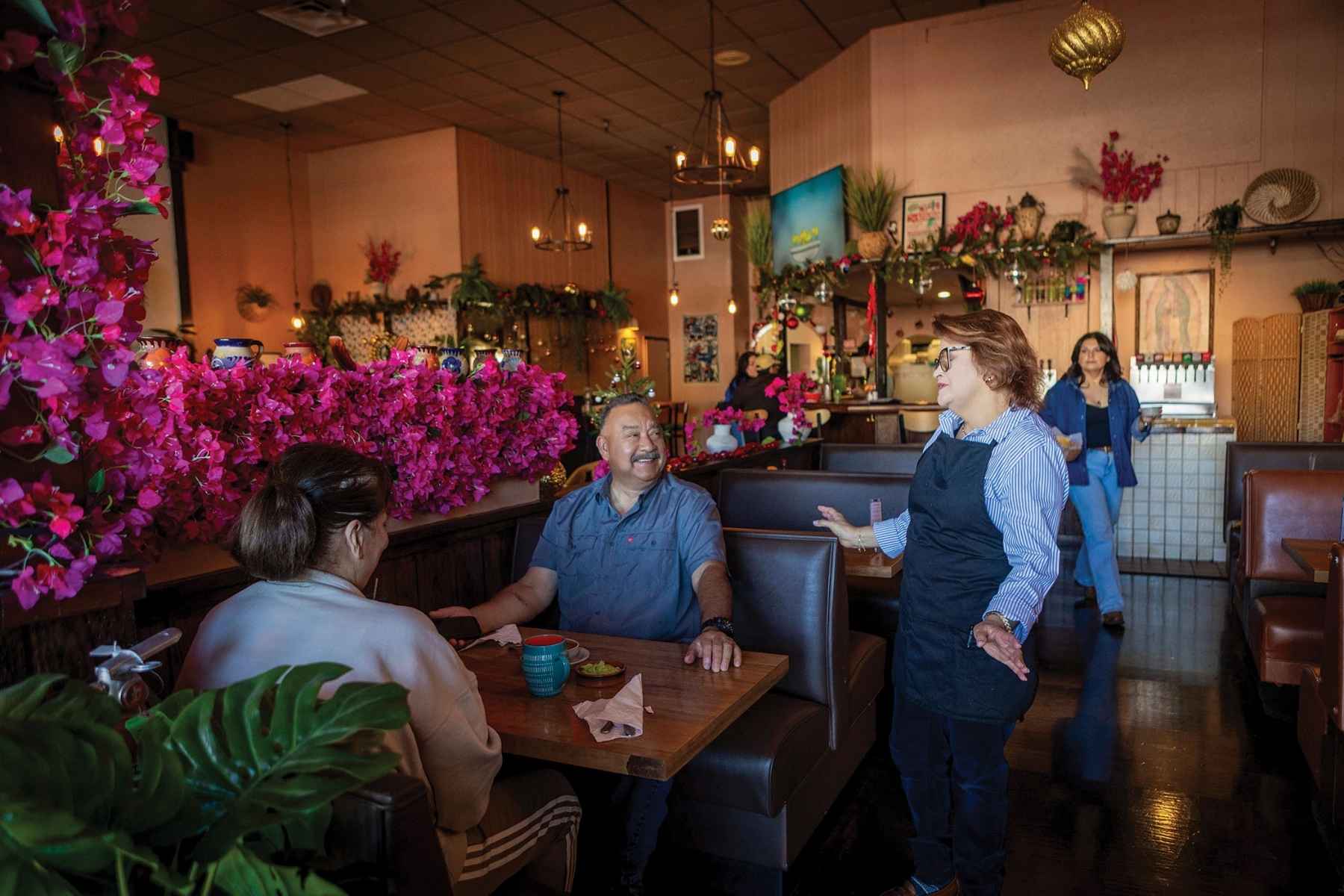 matriarch Ingrid, here with guests who feel like family. The easy conversation and warm smiles keep people coming back.